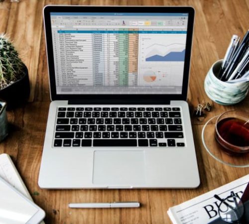 Laptop displaying data analysis and AI tools for SEO optimization.